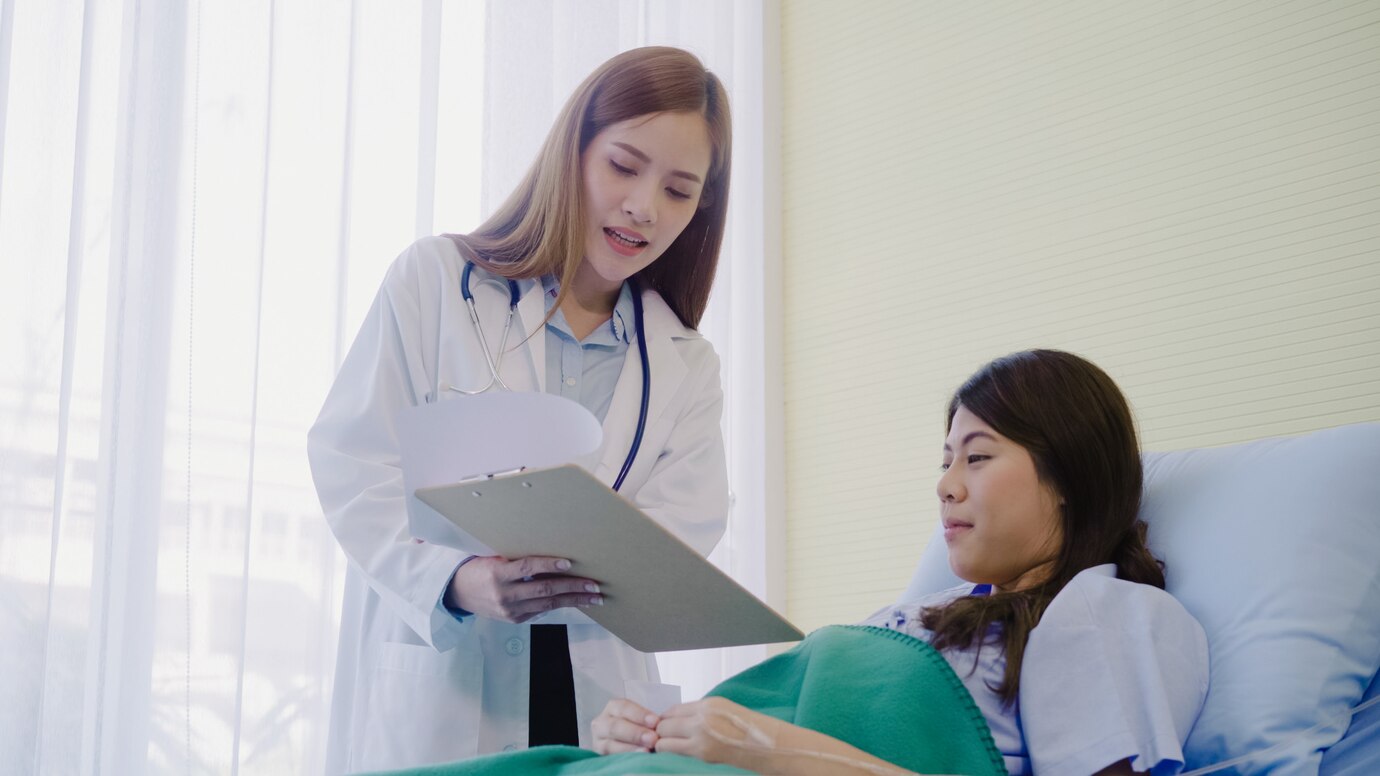beautiful smart asian doctor patient discussing explaining something with clipboard 7861 1218 Dr Ben Azouz Diagnostic & Minor Procedures
